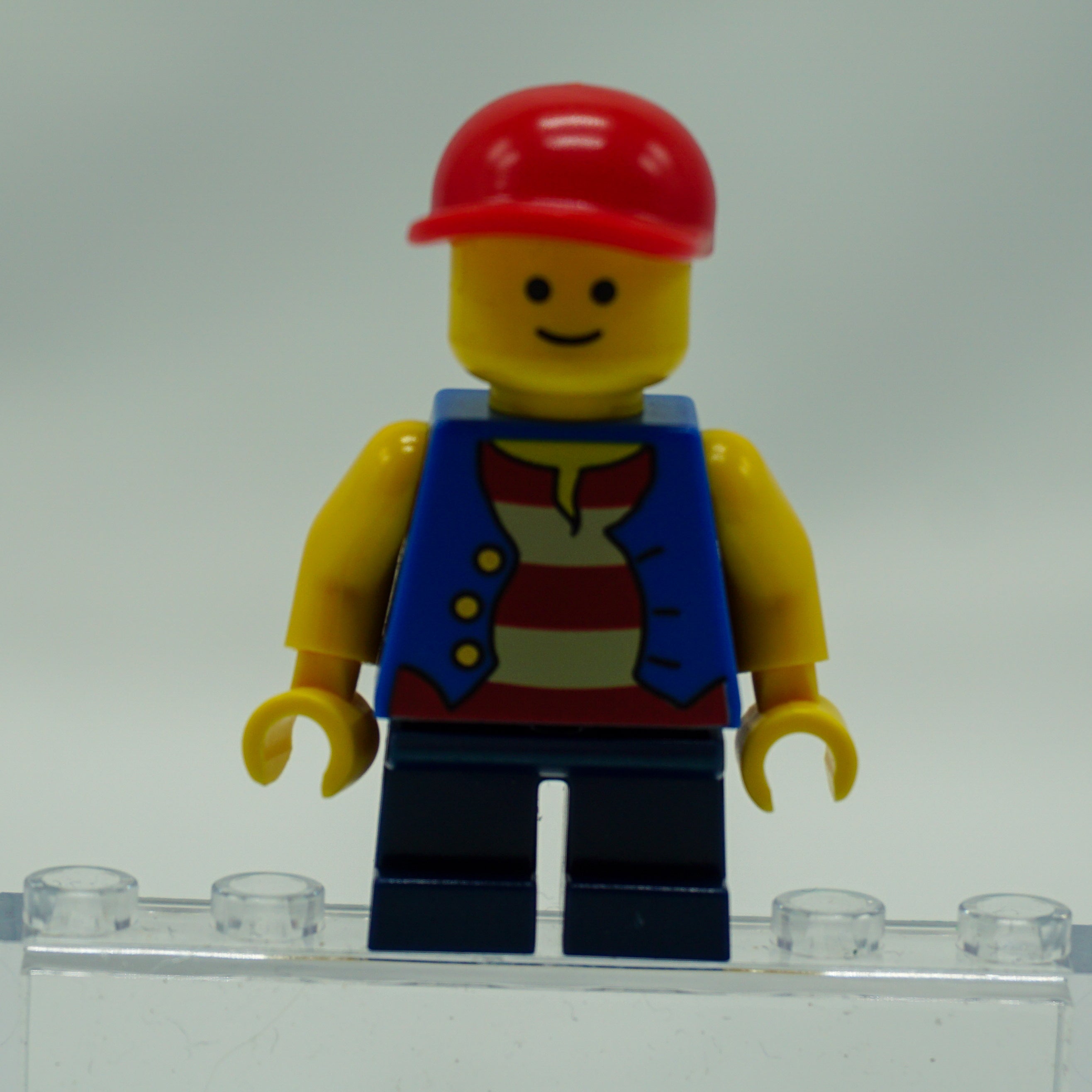 Minifig twn105 - Vest over Red and White Striped Shirt, Dark Blue Short Legs, Red Short Bill Cap